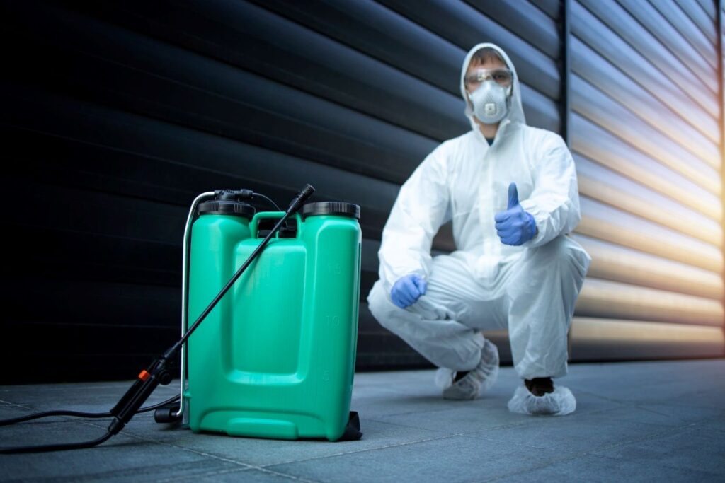 man holding a thumbs up behind a green spray bottle
